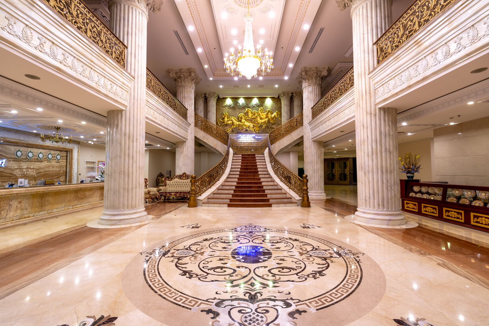 Illustrative grand hotel foyer with a marble staircase, not the actual property